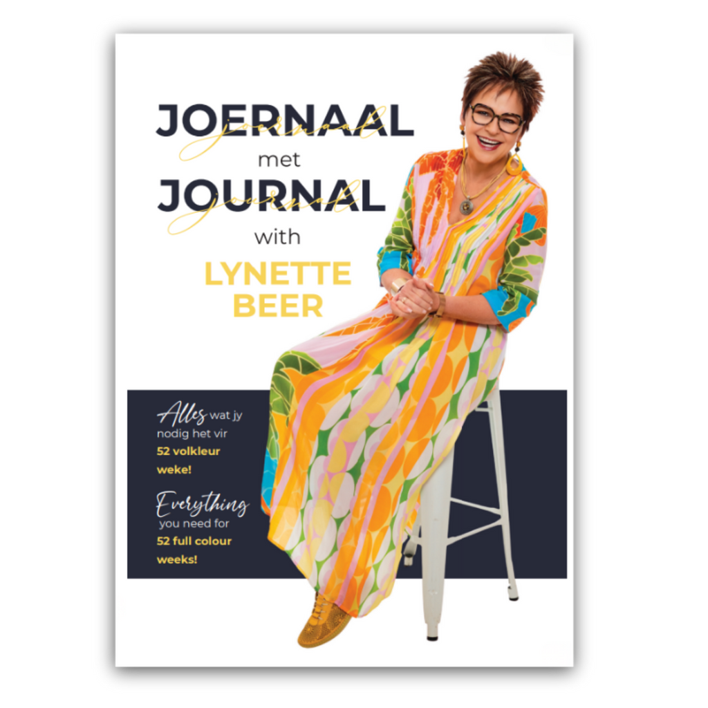 Book cover for 'Joernal met Journal with Lynette Beer' featuring a photo of Lynette Beer sitting on a white stool, wearing a vibrant multicolor patterned dress. The cover has a white background with dark navy and yellow text.