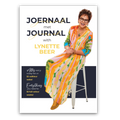Book cover for 'Joernal met Journal with Lynette Beer' featuring a photo of Lynette Beer sitting on a white stool, wearing a vibrant multicolor patterned dress. The cover has a white background with dark navy and yellow text.